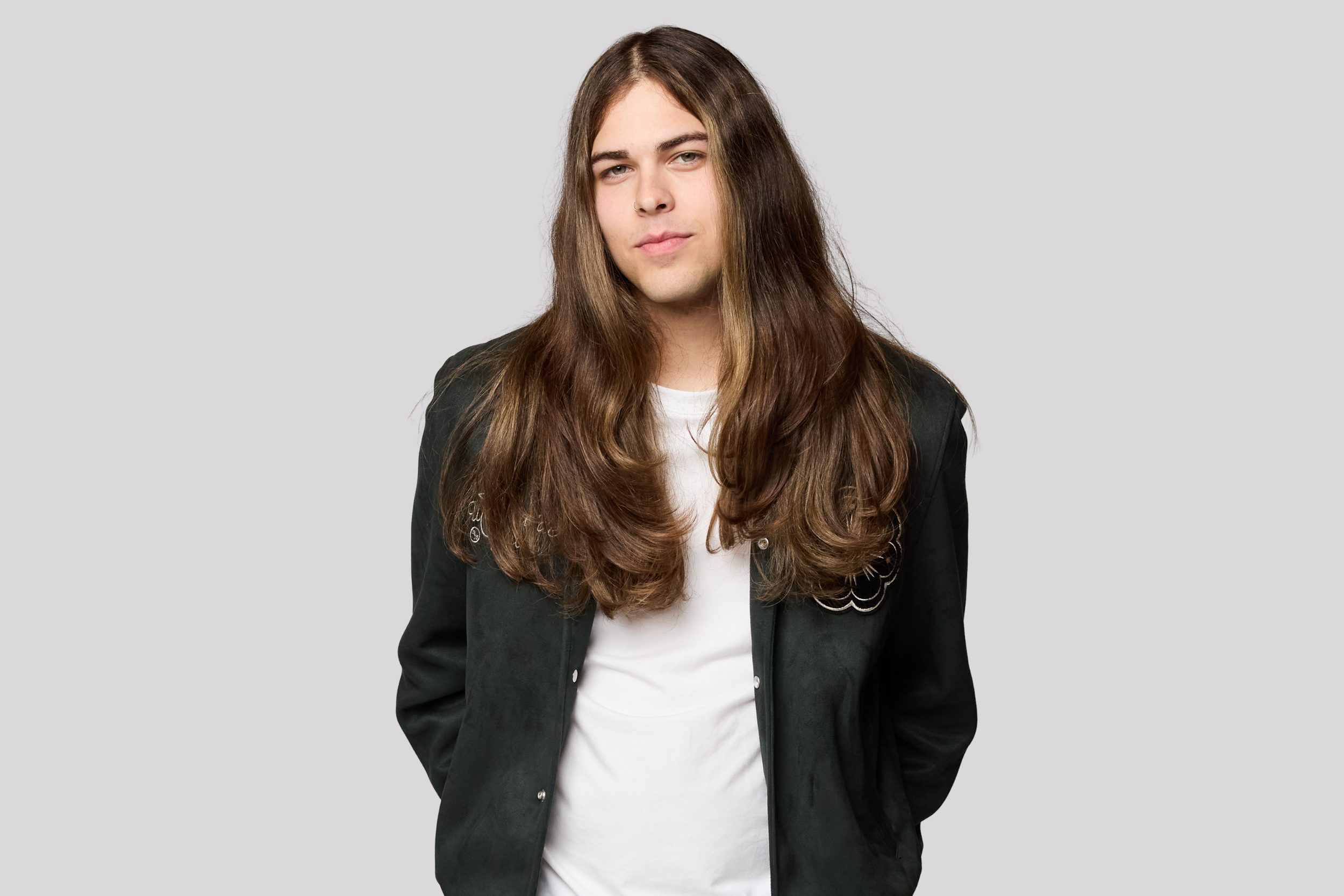 Studio portrait of Jourdan Blue against a gray backdrop